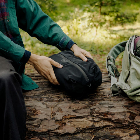 holding black ultralight packing cube inside a bag