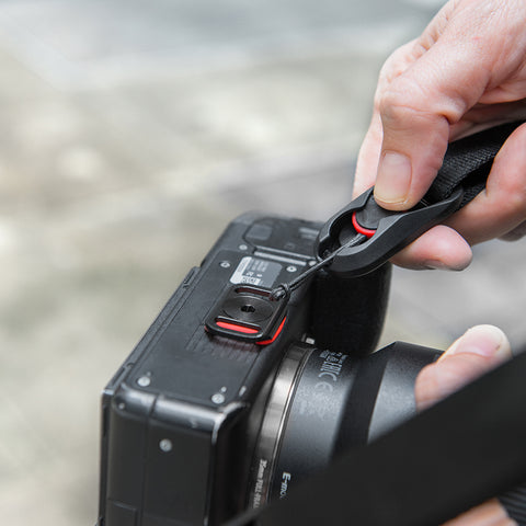 attaching strap on the anchor mount at the bottom of the camera