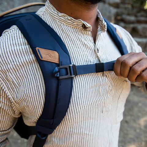 Joe is adjusting the sternum strap attached to the shoulder strap on his Midnight Everyday Backpack